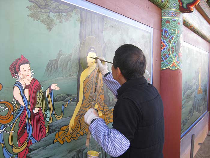 Man hand-painting murals